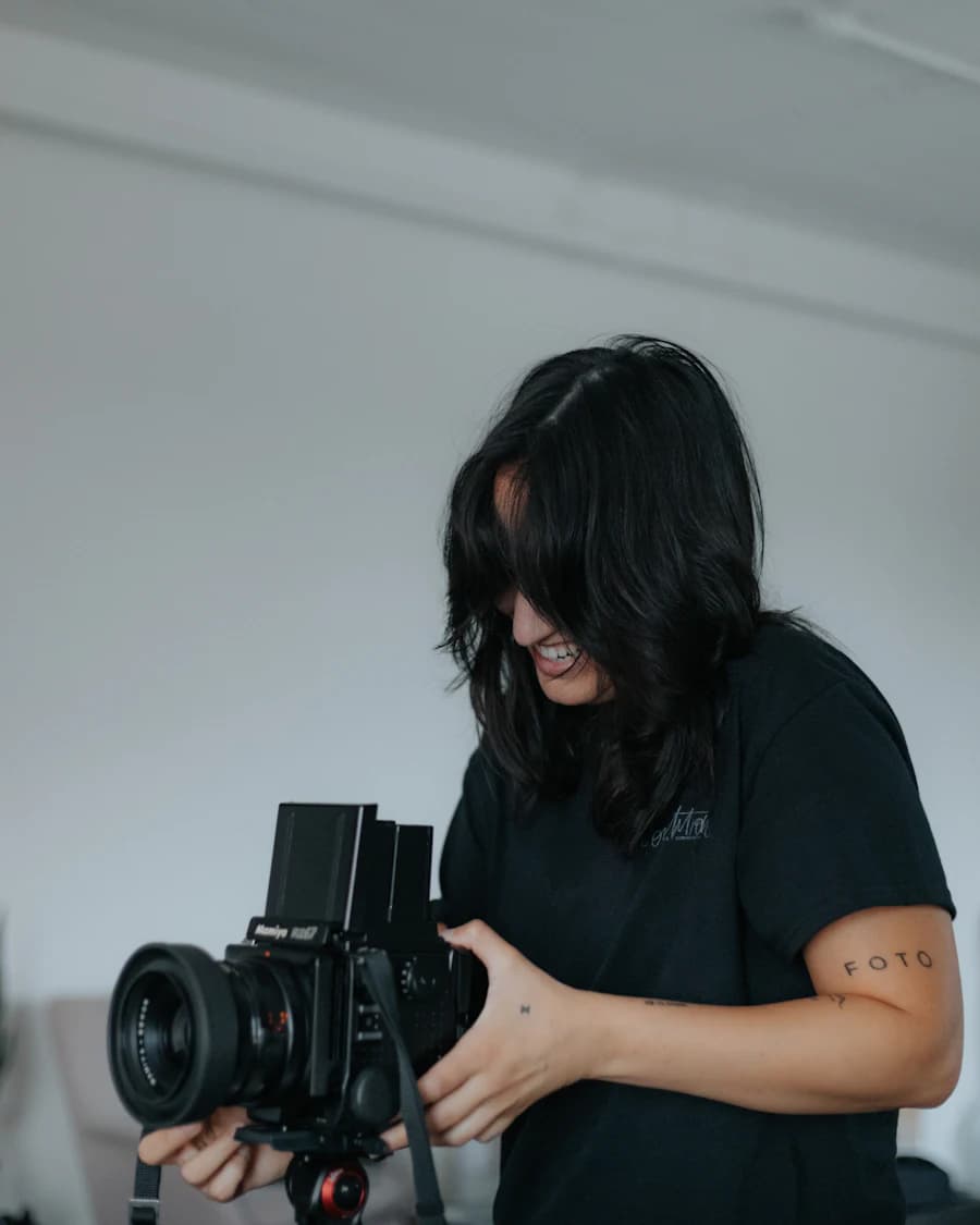 Woman adjusting a medium-format camera on a tripod