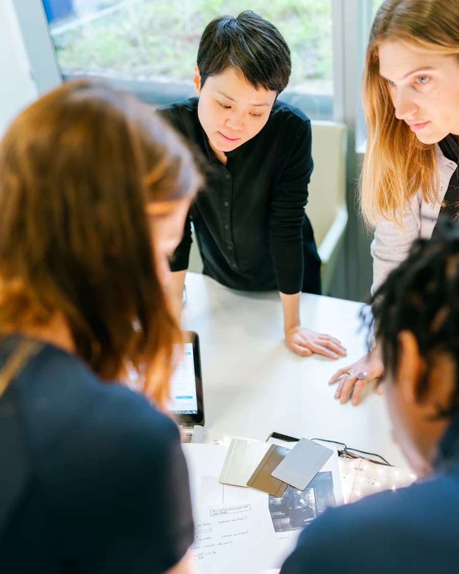 Small team leaning over a table, discussing material samples